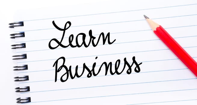 Learn Business written on notebook page with red pencil on the right