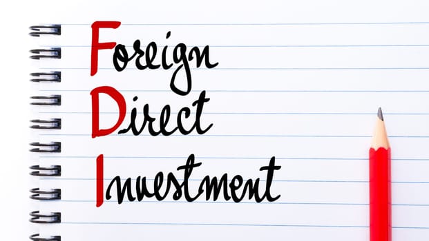 FDI Foreign Direct Investment written on notebook page with red pencil on the right