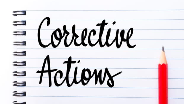 Corrective Actions written on notebook page with red pencil on the right