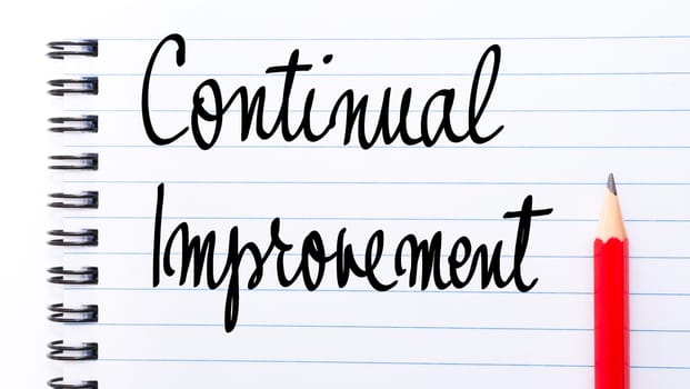 Continual Improvement written on notebook page with red pencil on the right