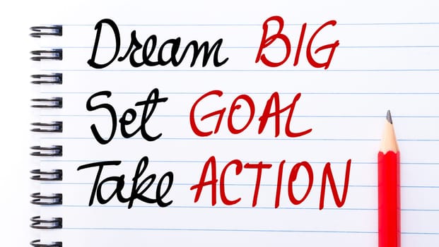 Dream BIG, Set GOAL, Take ACTION written on notebook page with red pencil on the right