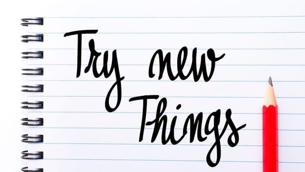 Try New Things written on notebook page with red pencil on the right