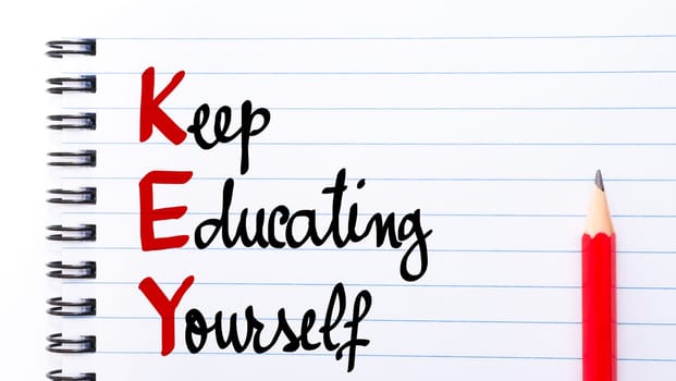 KEY Keep Educating Yourself written on notebook page with red pencil on the right