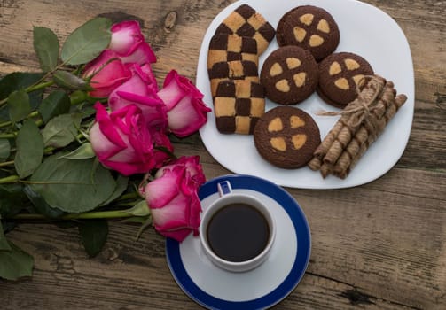 bouquet of red roses, plate with cookies, coffee, the top view
