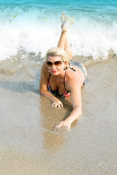 the beautiful woman who is creeping out of foam of sea waves