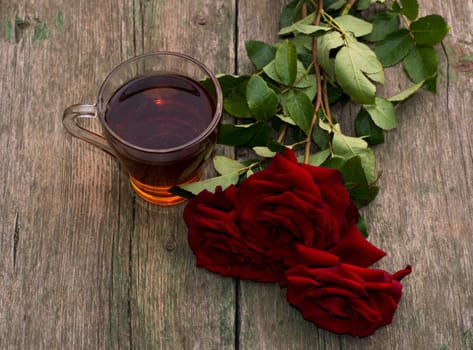 cup of tea and three red beautiful roses, still life, card, subject drinks