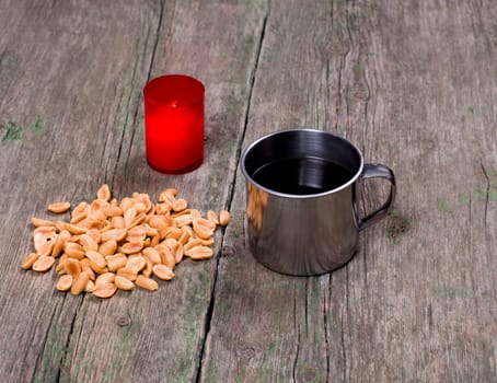 the burning candle, steel mug and peanut, subject food and drinks