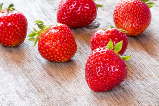 Close-up view of red strawberry on wooden floor