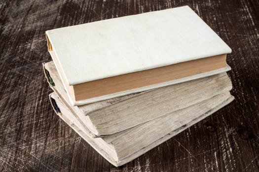 Vintage old books on wooden deck tabletop