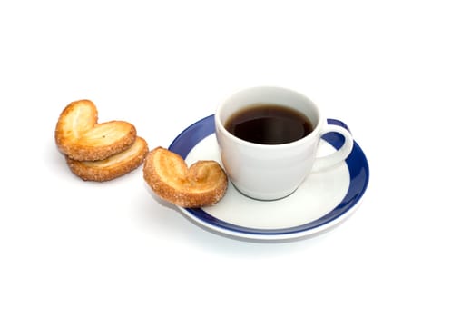 three cookies and cup of coffee on a saucer with a blue border, isolate, a still life on a subject drinks and sweets