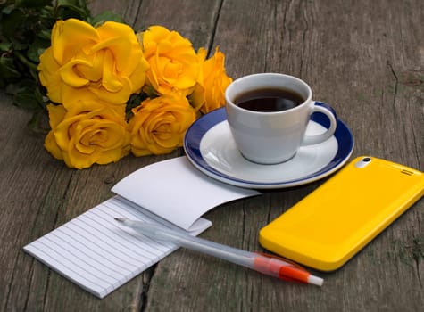 bouquet of yellow roses, phone, notebook and coffee, still life, festive card
