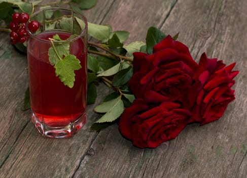 bouquet of red roses and glass with red drink, a subject drinks