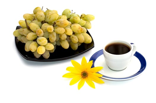 coffee still life, black plate with grapes and a yellow flower, a subject fruit and drinks