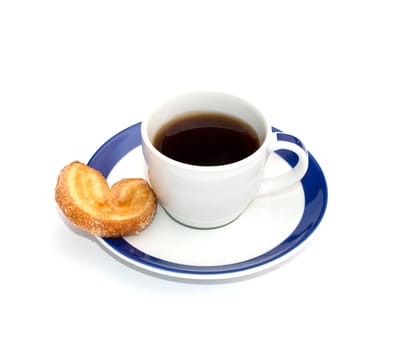 coffee on a saucer with a blue border and one cookies, a subject food and drinks