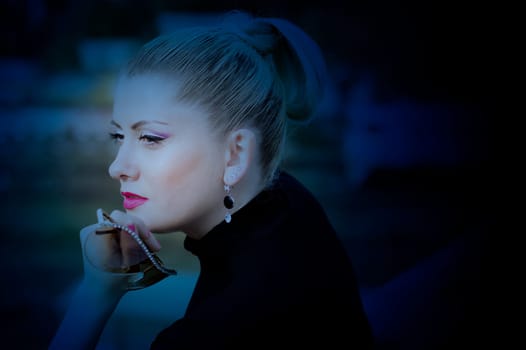 portrait of the beautiful woman at the railway station the art photo in blue tones, fall, the woman's subject in unusual places