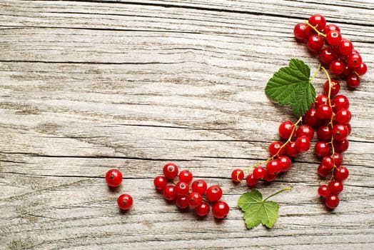 Red currant berries on a wooden table