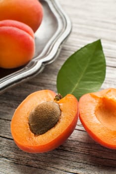 Fresh cut apricot fruits on wooden background