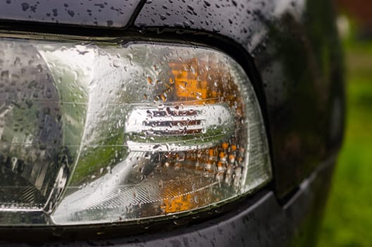 Car lights wet after the rain outdoors