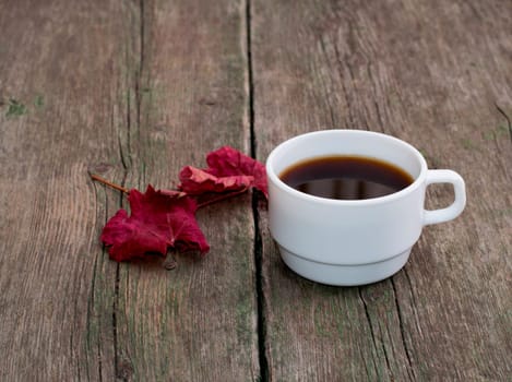 still life, coffee and brightly red leaf on a wooden table, fall, a subject drinks