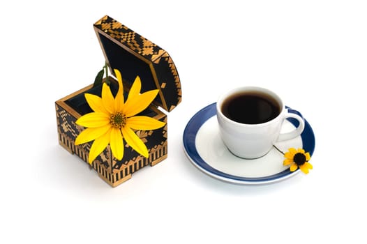 open casket with a flower and a cup of coffee, a still life, isolate, a subject drinks and flowers