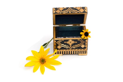 the open casket decorated with two yellow florets isolate, a still life, a subject fall