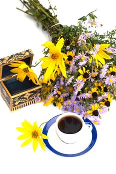 the open casket decorated with a bouquet of yellow flowers and coffee the top view, isolate, a still life, a subject fall, drinks and flowers