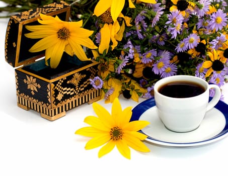 the open casket decorated yellow with flowers and coffee, isolate, still life, subject fall, drinks and flowers