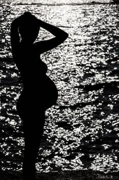 Silhouette of pregnant woman at the sunset at french riviera