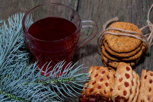 cup of tea, fir-tree branch and two linking of cookies, subject Christmas and New Year