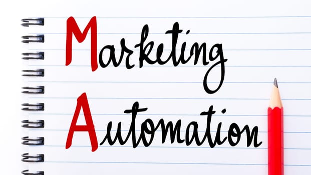 AM Marketing Automation written on notebook page with red pencil on the right