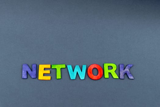 Word NETWORK created of wood letters on dark background, business concept, copy space available