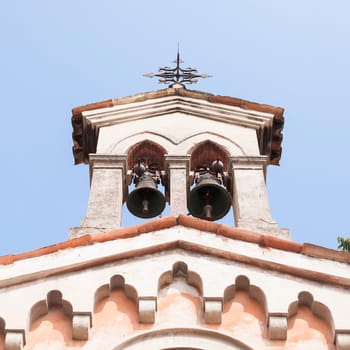 Small bell tower with a bell of a  church .