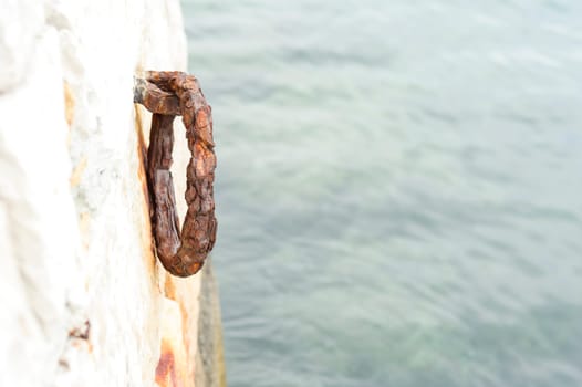 Old rustic ring for mooring boats on granite