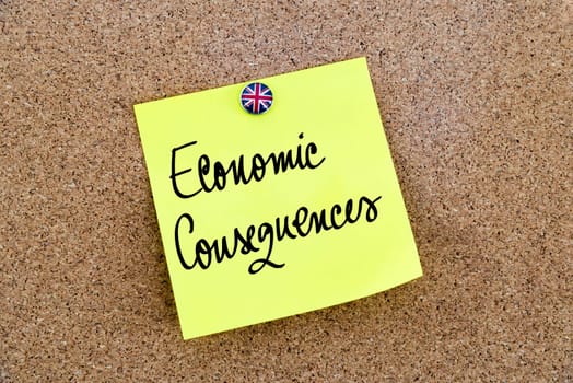Yellow paper note pinned on cork board with Great Britain flag thumbtack, written text ECONOMIC CONSEQUENCES, United Kingdom exit from European Union