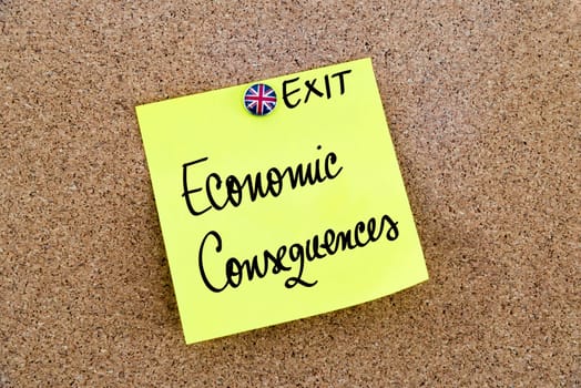 Yellow paper note pinned on cork board with Great Britain flag thumbtack, written text ECONOMIC CONSEQUENCES, United Kingdom exit from European Union