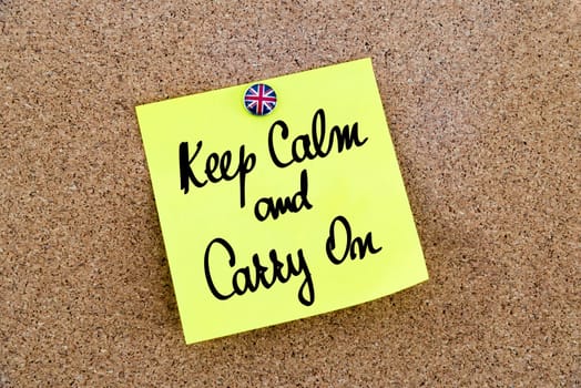 Yellow paper note pinned on cork board with Great Britain flag thumbtack, written text KEEP CALM AND CARRY ON, United Kingdom exit from European Union