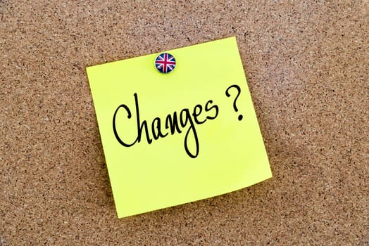 Yellow paper note pinned on cork board with Great Britain flag thumbtack, written text CHANGES ?, United Kingdom exit from European Union concept