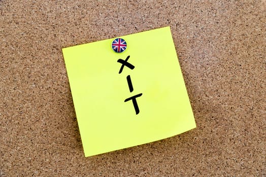 Yellow paper note pinned on cork board with Great Britain flag thumbtack, written text BREXIT, United Kingdom exit from European Union concept