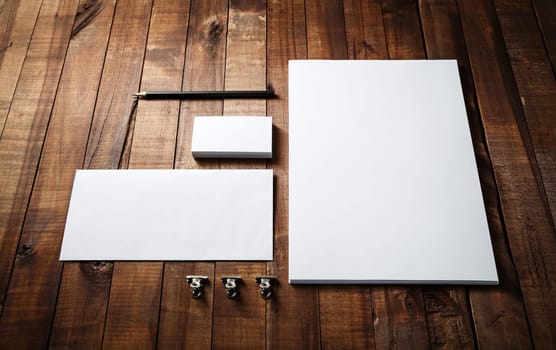 Photo of blank stationery set. Blank stationery template for branding identity for designers. Letterhead, business cards, envelope and pencil.