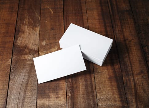 Blank business cards. Photo of blank business cards on vintage wooden table background. Mock-up for branding identity. For design presentations and portfolios.