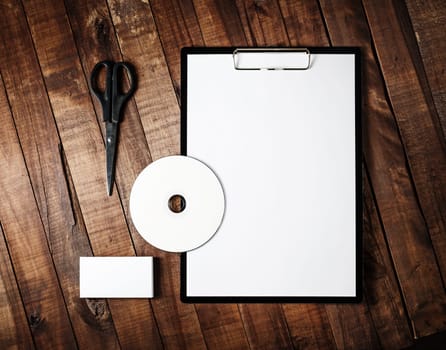 Photo of blank stationery template for branding identity for designers. Blank stationery set on vintage wooden table background. Corporate identity template. Top view.