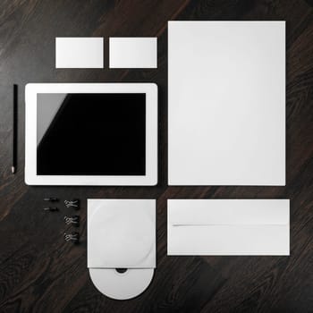 Corporate identity template on dark wooden background. For design presentations and portfolios. Top view.