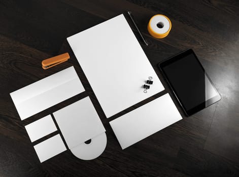 Corporate stationery on wooden background. Top view.