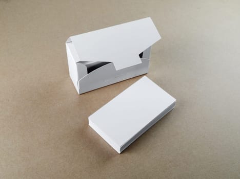 Blank business cards and a box for them on the table. Template for branding identity.