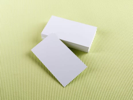 Blank business cards on green background. Template for ID.