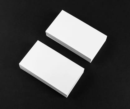 Photo of blank business cards on black background. Mock-up for branding identity. Mock-up for ID.