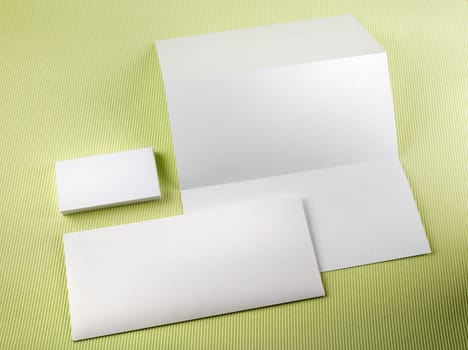 Blank stationery set on a green background. Template for branding identity.