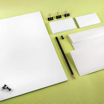 Branding identity set on a green background. Top view.