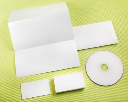 Blank stationery set on green background. Template for branding identity. Top view.