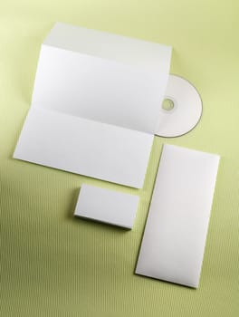 Template for branding identity on green background. Blank corporate identity set. Vertical shot.